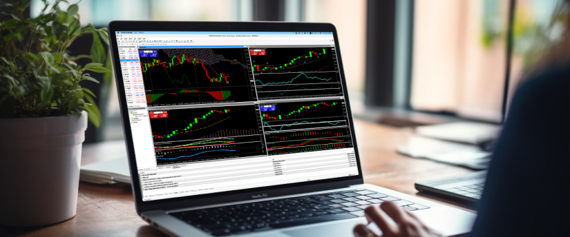 A person utilizing a laptop to track stock market fluctuations, surrounded by financial reports and market analysis tools.