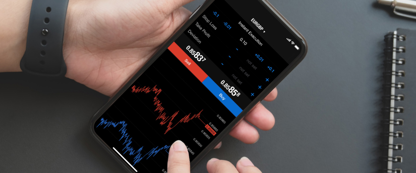 a trader hold a phone with forex diagrams