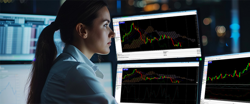 Day trader executing technical analysis on trading screens with the best forex broker for day trading.