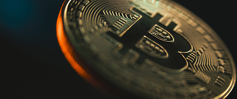 Close-up shot of a gold Bitcoin token symbolizing overall bullish and bearish shifts in current crypto market sentiment.