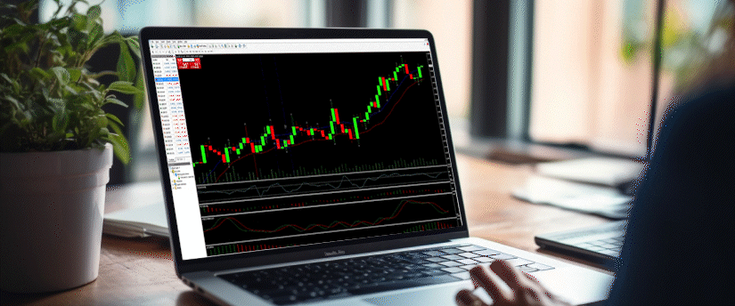A close-up view of a laptop display showing live candlestick charts and technical indicators, used for executing a precise forex price action scalping strategy.